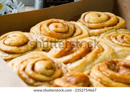 Close up of fresh Cinnamon rolls or Cinnamon buns in a box. Selective focus.