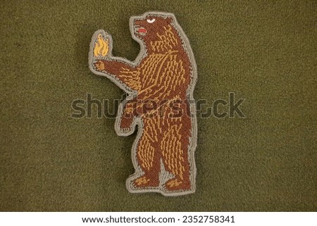 The fire bear emblem patch is velcro, used for attaching clothes and bags.