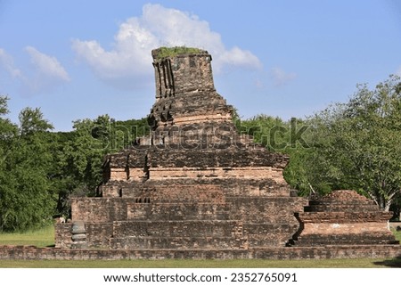Ancient of Pagoda and green leaves with blue sky background in National Park of Sukhothai

