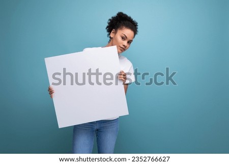 young latin brunette female student presenting her study project on a white easel with mockup