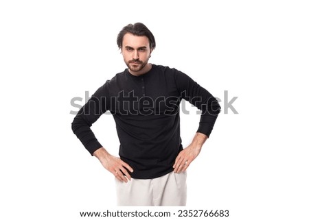 authentic brutal macho man with black hair and beard with an earring in his ear isolated on white background with copy space Royalty-Free Stock Photo #2352766683