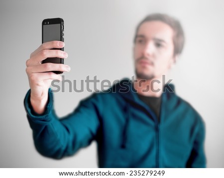 Young man taking a selfie photo. Isolated
