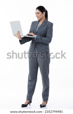 Young Indian businesswoman working on a laptop at isolated on white studio background. 