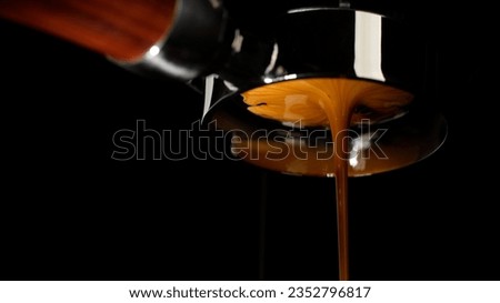 Pouring coffee espresso stream through Bottomless Portafilter. Creamy and perfectly pulled espresso Royalty-Free Stock Photo #2352796817