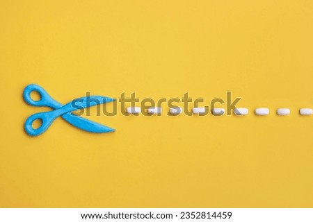 Plasticine 3d scissors with cut lines on yellow background. Concept of craft works, design or fashion, DIY tools.