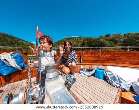 A family on the excursion boat cruise around the island of Ithaki or Ithaca in the Ionian sea in the Mediterranean sea of Greece
