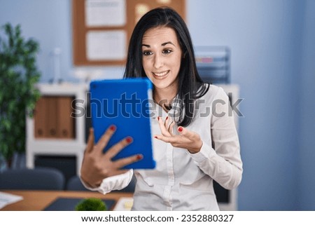 Young caucasian woman business worker smiling confident having video call at office