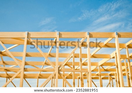 construction of a building made of wood in the background blue sky.