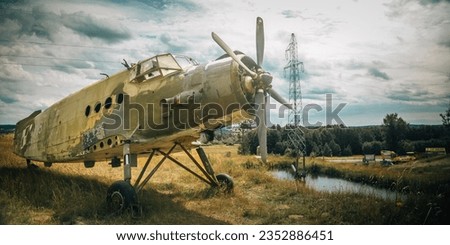 Old historic military camouflage propeller plane at an exhibition Royalty-Free Stock Photo #2352886451