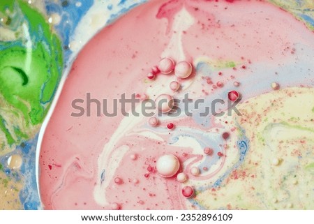 Mosaic of oil, milk and paints sparkling with beautiful colors and shapes