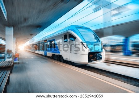 Blue high speed train in motion on the railway station. Fast moving modern intercity train and blurred background. Railway platform. Railroad in Slovenia. Commercial. Passenger railway transportation	 Royalty-Free Stock Photo #2352941059