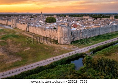 The ramparts, towers and tiled roofs of the historical walled town Aigues-Mortes in Camargue region, southern France Royalty-Free Stock Photo #2352947551