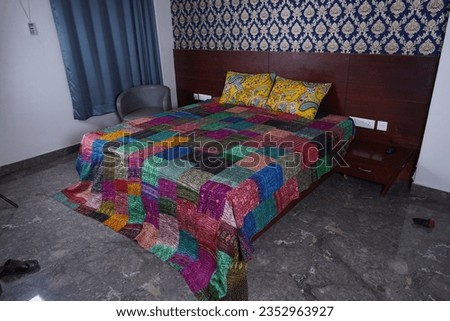 colourful Rajai on the bed
