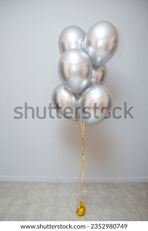 bunch of chrome silver balloons in the room
