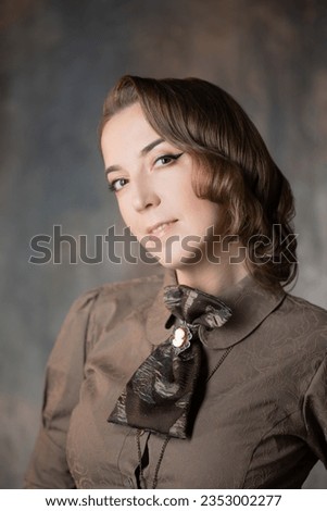 Stylish lady in an elegant suit in Victorian style, suit with steampunk elements, close-up portrait Royalty-Free Stock Photo #2353002277