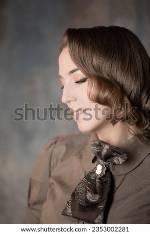 Stylish lady in an elegant suit in Victorian style, suit with steampunk elements, close-up portrait Royalty-Free Stock Photo #2353002281