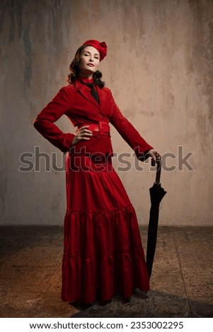 Mary Poppins. A stylish lady in a red old-fashioned suit with a hat and a lace umbrella Royalty-Free Stock Photo #2353002295