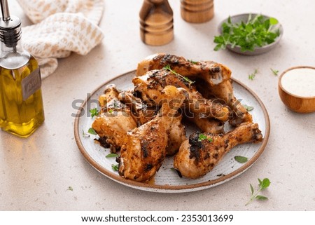 Roasted chicken drumsticks with garlic and herbs served with ranch Royalty-Free Stock Photo #2353013699