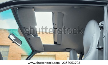 Sun roof of a car open Royalty-Free Stock Photo #2353053703