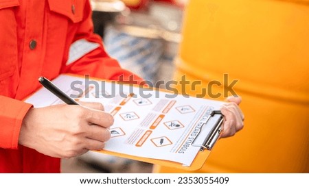 An environmental engineer is using hazardous material checklist form to correct the chemical safety at the factory storage area. Industrial work, photo applied with sunlighting and len flare effect. 