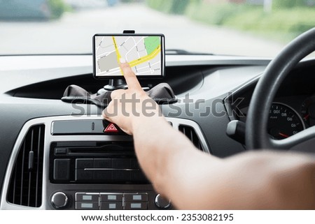 Close-up Of Female's Hand Using GPS Navigation Inside Car Royalty-Free Stock Photo #2353082195
