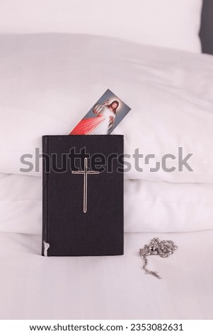 Bible, rosary and  picture of Jesus on a bed. Religion at home. 