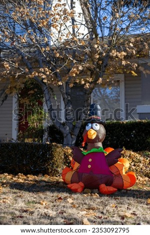 Inflatable turkey figure in the hat in the park. Thanksgiving decoration. Traditional Thanksgiving yard decor. Turkey shape balloon