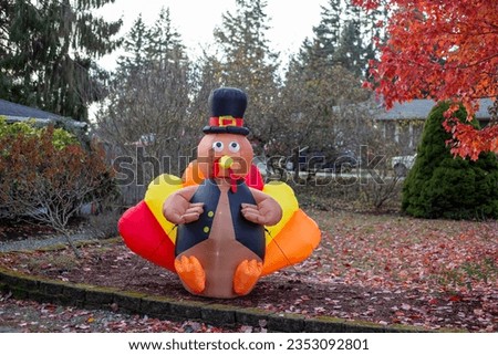 Outdoor Thanksgiving decoration. Inflatable turkey figure in the hat. Traditional Thanksgiving yard decor. Turkey shape balloon