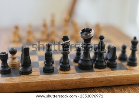 Wedding bands on tops of chess game board pieces. Concept for power and teamwork.
