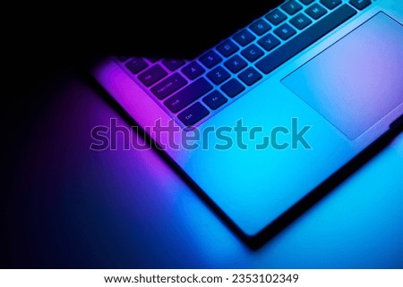 Close up image of laptop in dark neon light. technology, internet, business concept