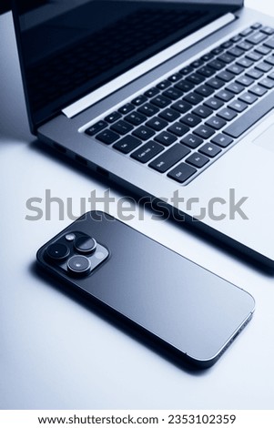 Laptop with smartphone. Close up image. Technology, internet, business concept Royalty-Free Stock Photo #2353102359