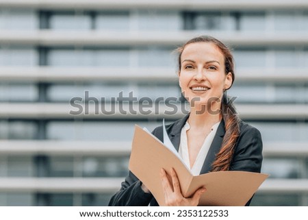 business woman with document folder in the street
