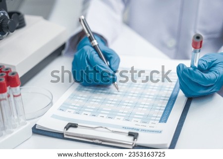 Image of a researcher's hands testing water quality in a lab.Effects of Water Pollution on Human Health and Disease Royalty-Free Stock Photo #2353163725