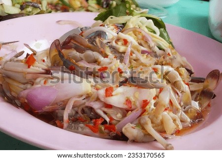 a photography of a plate of food with a spoon and fork, homarus americanus salad with clams and onions in a pink bowl.