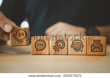 Businessman hand choose wooden block cube symbol icon contact us. Wooden cubes with symbols customer service and contact us. Customer support concept