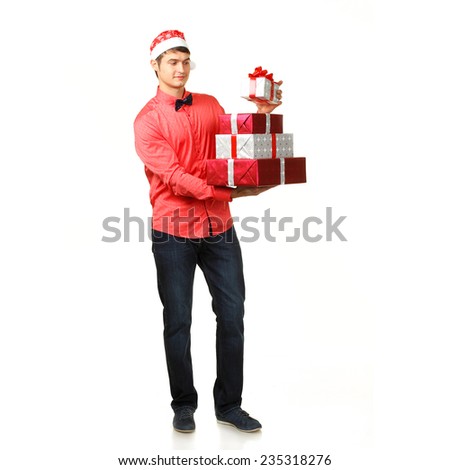 male in Santa hat gives a lot of Christmas gifts