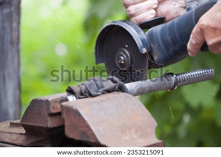 Heavy industry worker cutting steel with angle grinder. Cutting an old rusty pipe. dismantling. close-up. old pipe and work with grinder Royalty-Free Stock Photo #2353215091