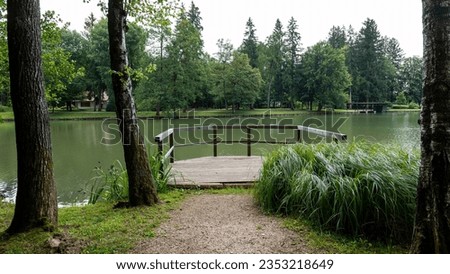 Park with a lake and forest surrounding it in Slovenia.