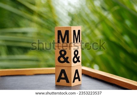 The letters M and S written on wood cubes. bokeh nature background. M and A - short for Mergers and Acquisitions, business concept. Royalty-Free Stock Photo #2353223537