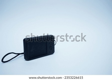 close up of a pocket camera on a plain white background.