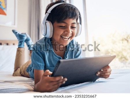 Happy boy, tablet and headphones on bed, smile or relax for streaming subscription, movie or funny video. Male child, digital touchscreen and happy in bedroom with audio tech, show or cartoon in home