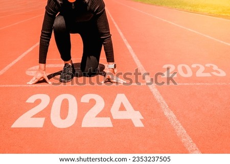 2024 Newyear , Athlete Woman starting on line for start running with number 2023 Start to new year. Royalty-Free Stock Photo #2353237505