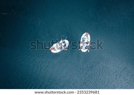 An aerial top shot of two boats sailing in the river near Fanforsen, Bjorbo, Sweden