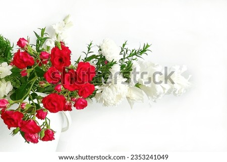 Beautiful Flower Bouquet. Close-up of a Summer Bouquet of Flowers from Roses and Peonies on a Light Background.