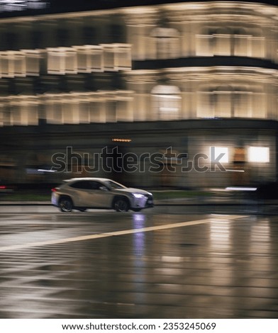 A blurry shot of a car driving in the evening