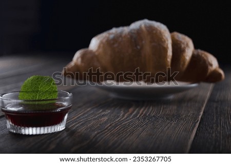 Concept of delicious food with croissants with  jam on black smokey background