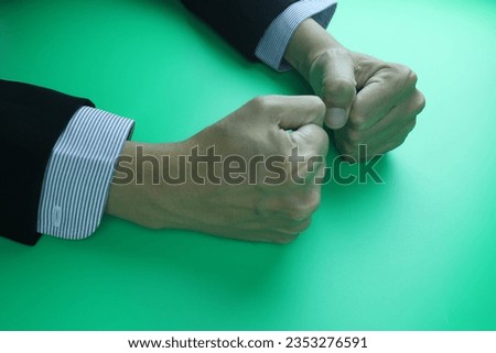 man businessman shirt suit is being angry anger his fist vibrating shaking on the director desk table feel furious displease stress frustrated aggressive gesture client talking argument  Royalty-Free Stock Photo #2353276591