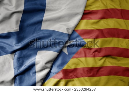 big waving national colorful flag of finland and national flag of catalonia . macro