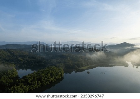 Drone view of Kerala nature, morning landscape image of Edakkanam river, Mountain view with foggy weather