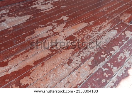 Peeled of old wooden parquet. Dirty wooden floor. Brown of the weathered wooden floor for background.